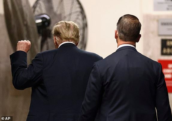 Former President Donald Trump gestures, as he enters Manhattan criminal court during closing arguments in his criminal hush money trial in New York, Tuesday, May 28, 2024.   (Andrew Kelly/Pool Photo via AP)