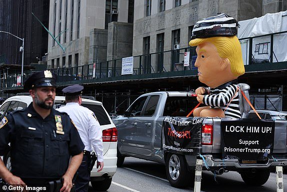 NEW YORK, NEW YORK - MAY 28: An anti-Trump protestor drives past Manhattan Criminal Court with an inflatable baby Trump balloon on May 28, 2024 in New York City. Closing arguments are under way in former U.S. President Donald Trump's hush money trial. The former president faces 34 felony counts of falsifying business records in the first of his criminal cases to go to trial.  (Photo by Michael M. Santiago/Getty Images)
