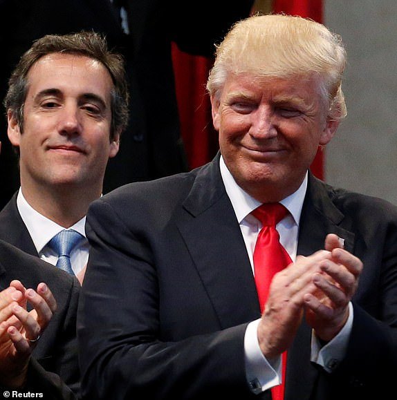 Republican presidential nominee Donald Trump's personal attorney Michael Cohen stands behind Trump after a group of supporters plus vice presidential nominee Mike Pence laid hands on Trump in prayer during a campaign stop at the New Spirit Revival Center church in Cleveland Heights, Ohio, U.S. September 21, 2016. Picture taken September 21, 2016. REUTERS/Jonathan Ernst - RC11D2EECA30