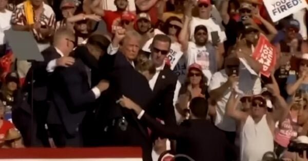 Formner President Donald Trump is escorted from Saturday's rally by Secret Service agents.