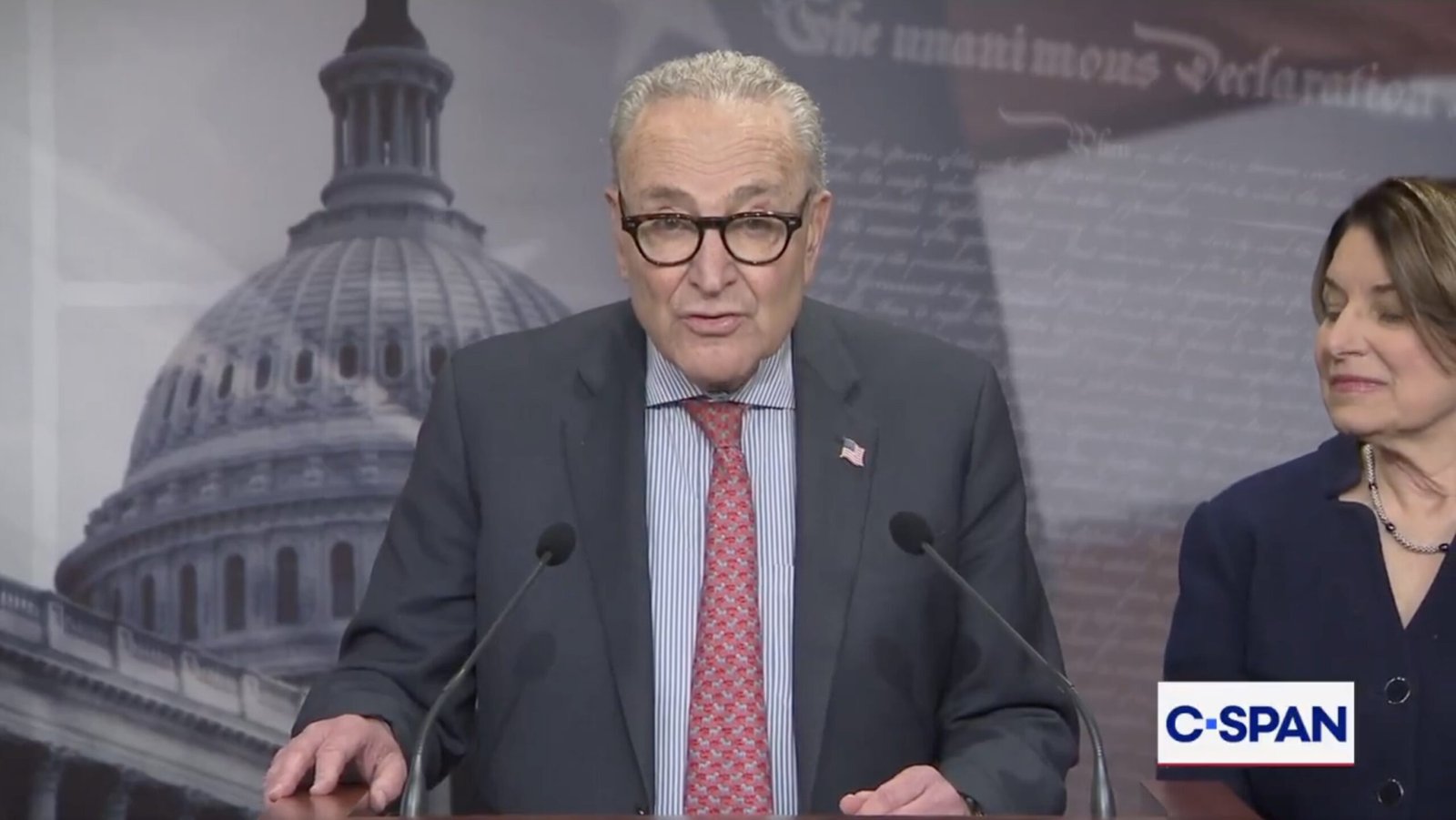 Senator Chuck Schumer speaks at a press conference in front of the U.S. Capitol, addressing key legislative issues with Senator Amy Klobuchar by his side.