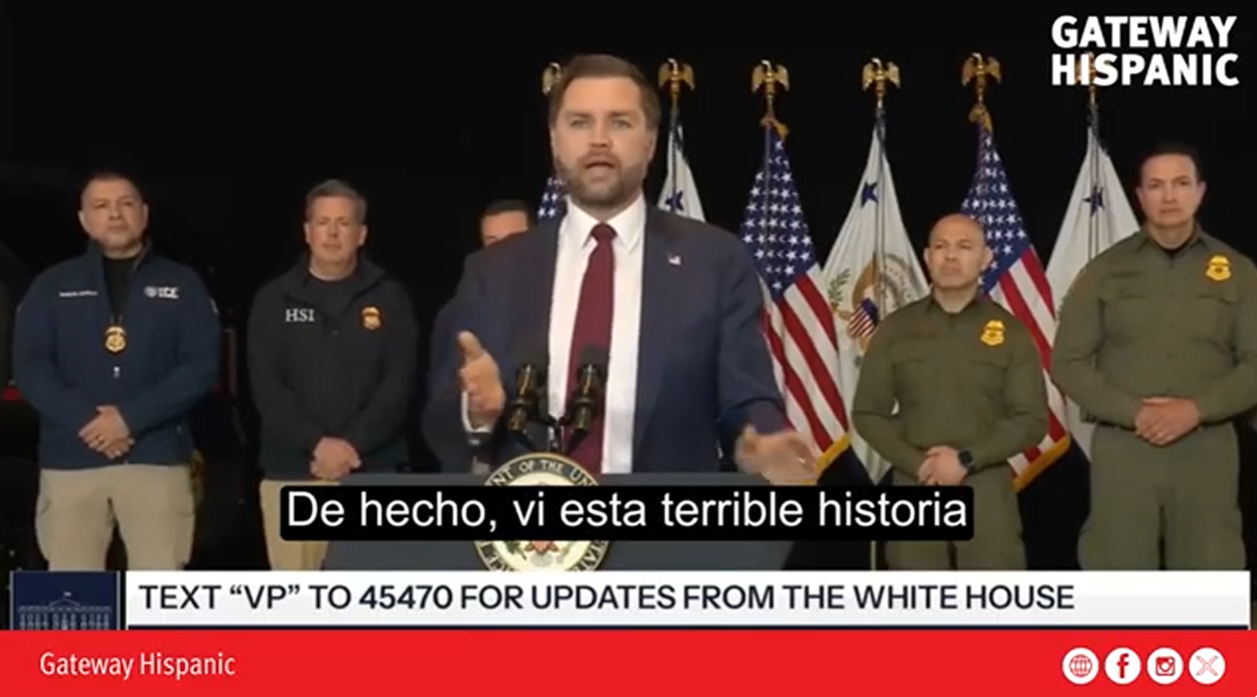 A speaker addresses an audience about a serious issue, flanked by law enforcement officials and U.S. flags, during a press conference.