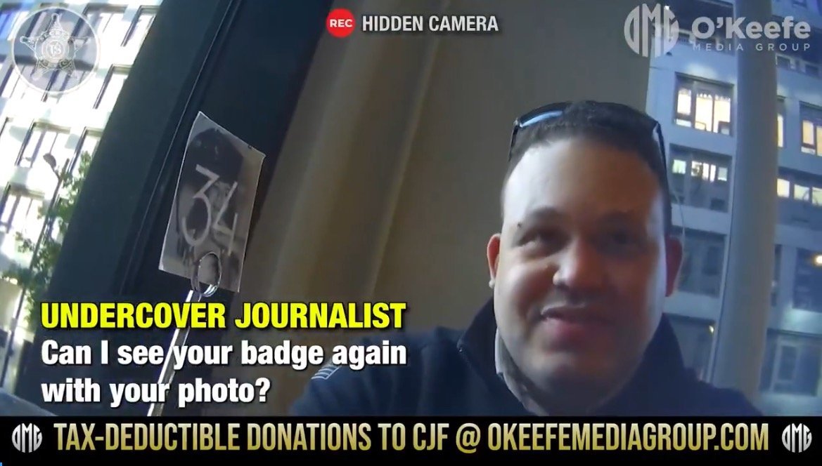 Undercover journalist interacting with an individual in a public space, requesting to see identification badge for verification.