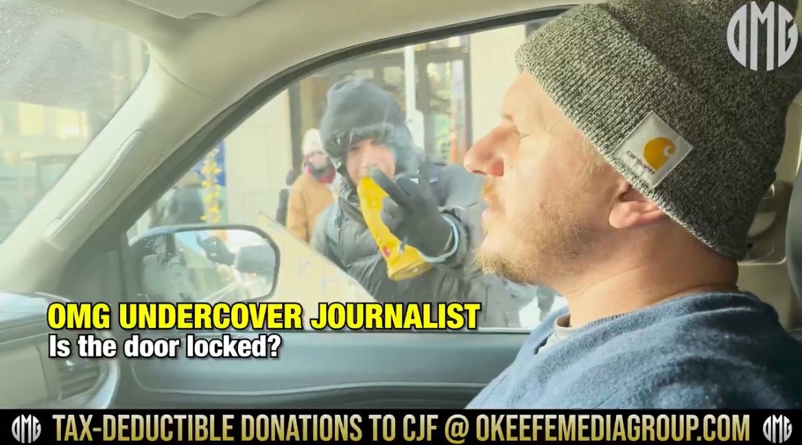 Undercover journalist in a car asking if the door is locked while a person approaches outside.