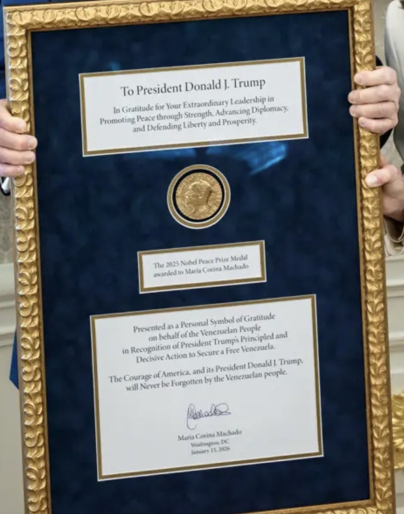 Framed certificate honoring Donald J. Trump for his leadership in promoting peace, featuring a Nobel Peace Prize medal awarded to Maria Corina Machado.