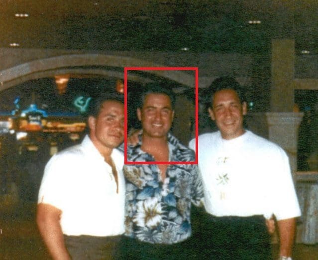 Three men pose together in a casino, wearing casual attire with a lively background showcasing gaming and entertainment.