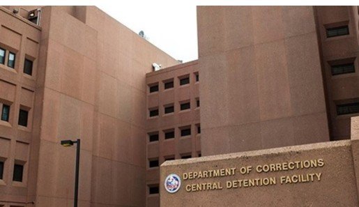 Central Detention Facility building exterior featuring the Department of Corrections signage, showcasing a modern design and secure environment.