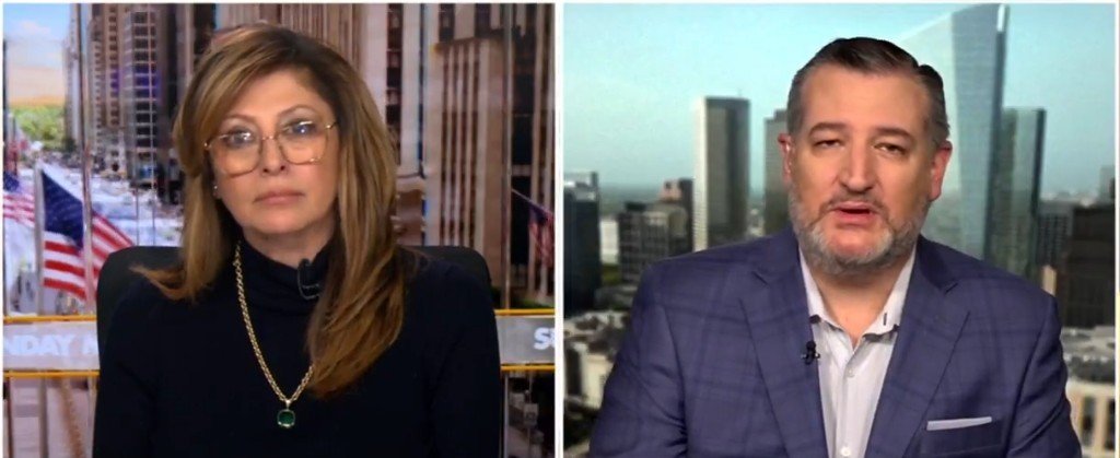 News segment featuring a political discussion between two hosts, with a city skyline in the background and American flags visible.