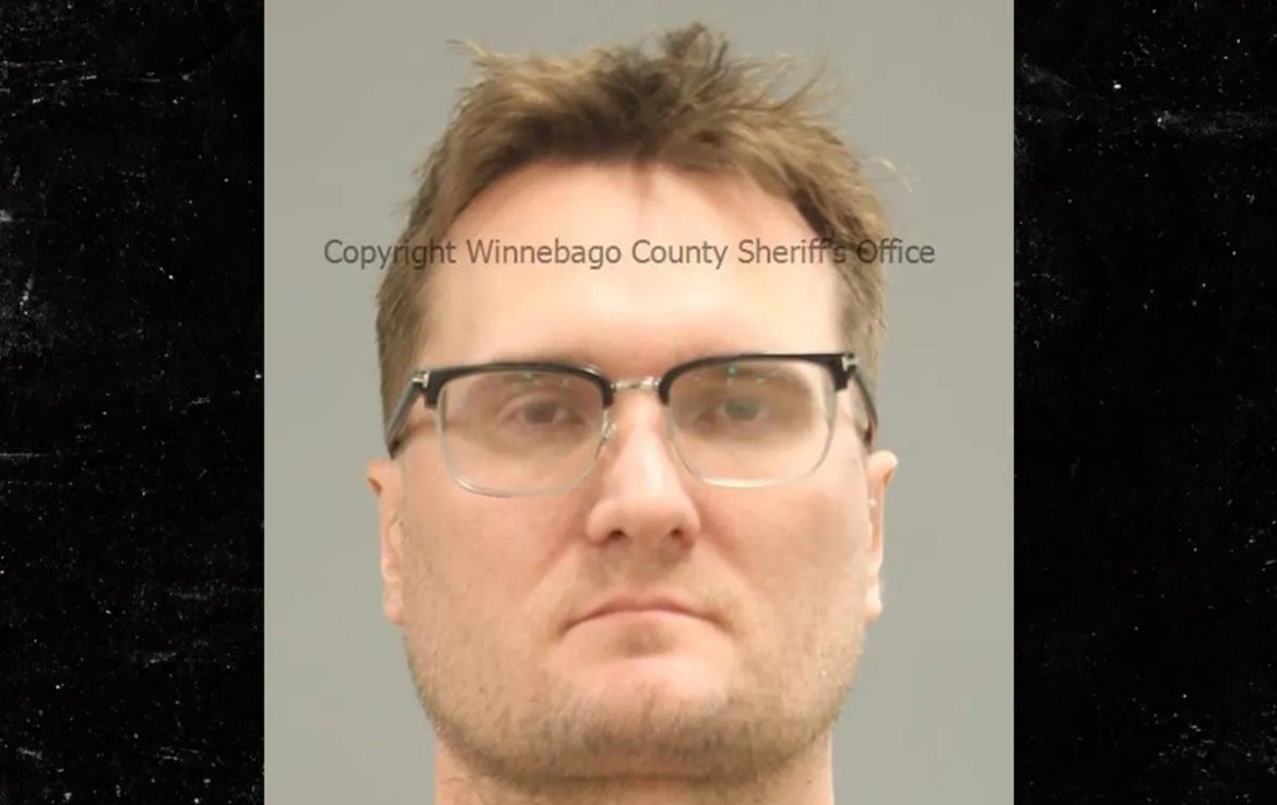 Mugshot of a male individual with short hair and glasses, taken by the Winnebago County Sheriff's Office.
