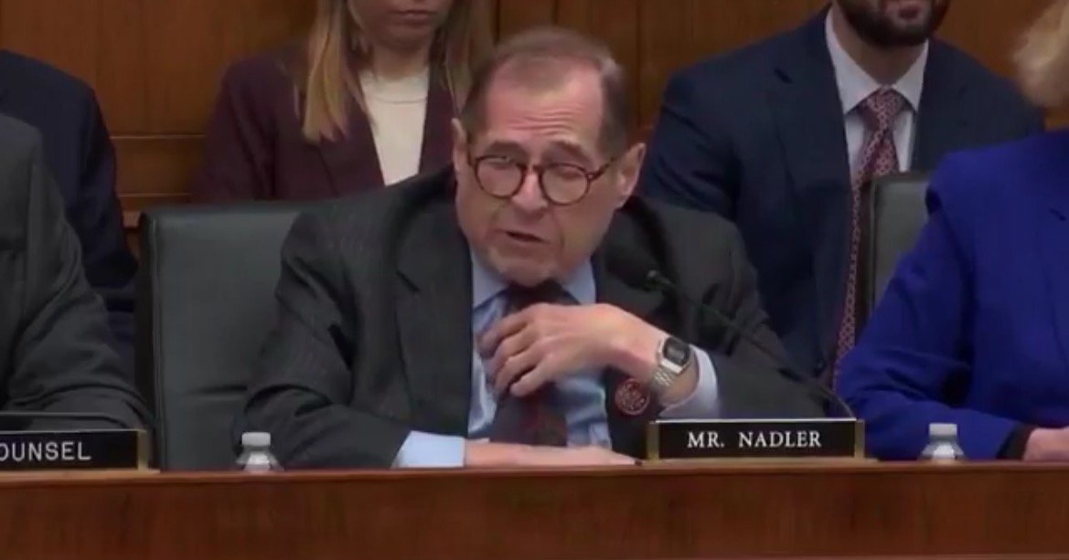 Congressman Jerry Nadler speaking during a committee hearing, seated at a table with colleagues, displaying a serious expression and gesturing thoughtfully.