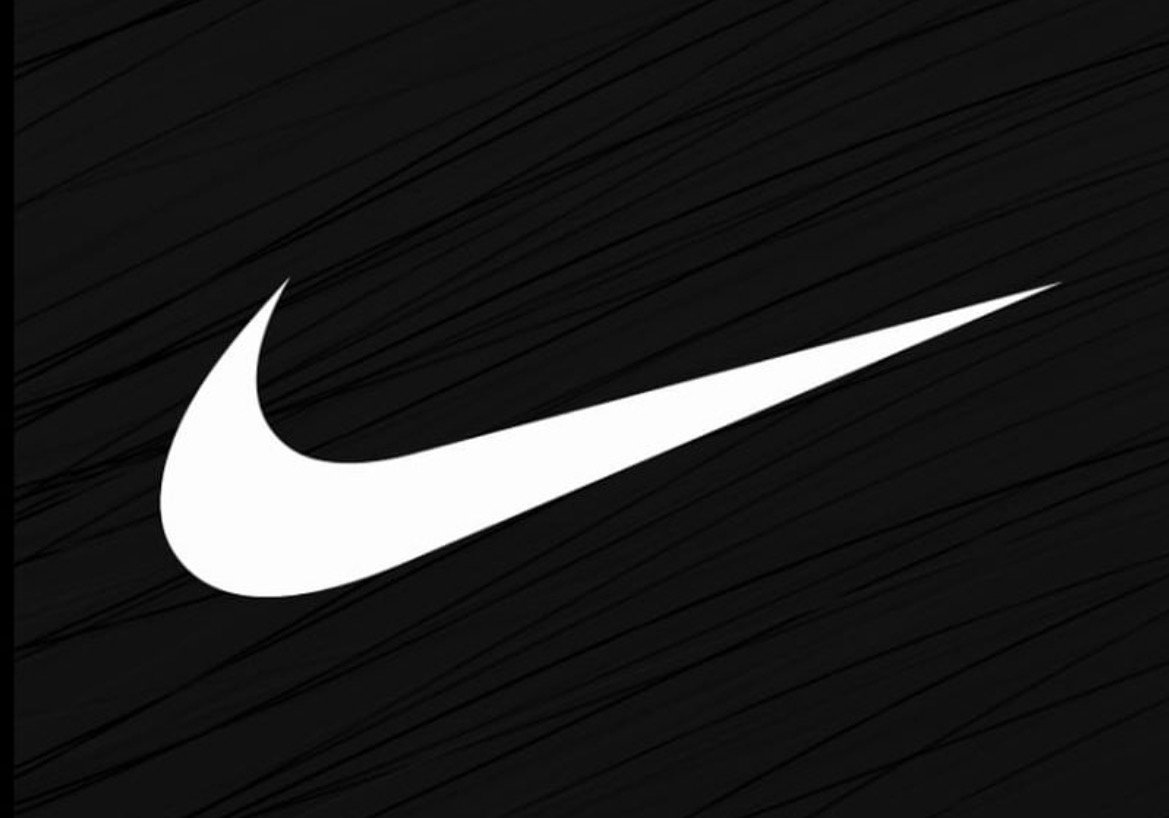 Nike logo in white on a black textured background, representing the brand's focus on athleticism and innovation.