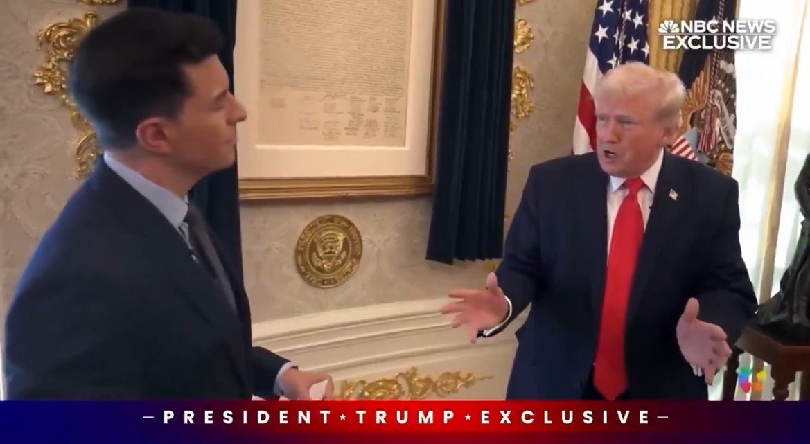 Former President Donald Trump speaks during an exclusive interview in the Oval Office, with a backdrop of the presidential seal and flags.