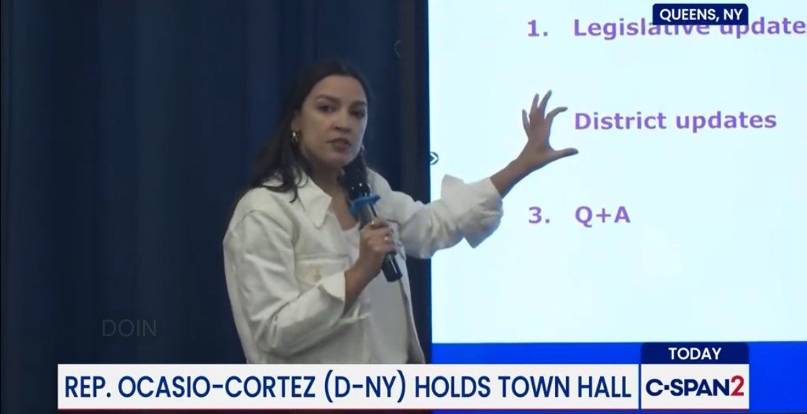 Rep. Ocasio-Cortez leads a town hall in Queens, NY, discussing legislative updates and engaging with constituents during a Q&A session.