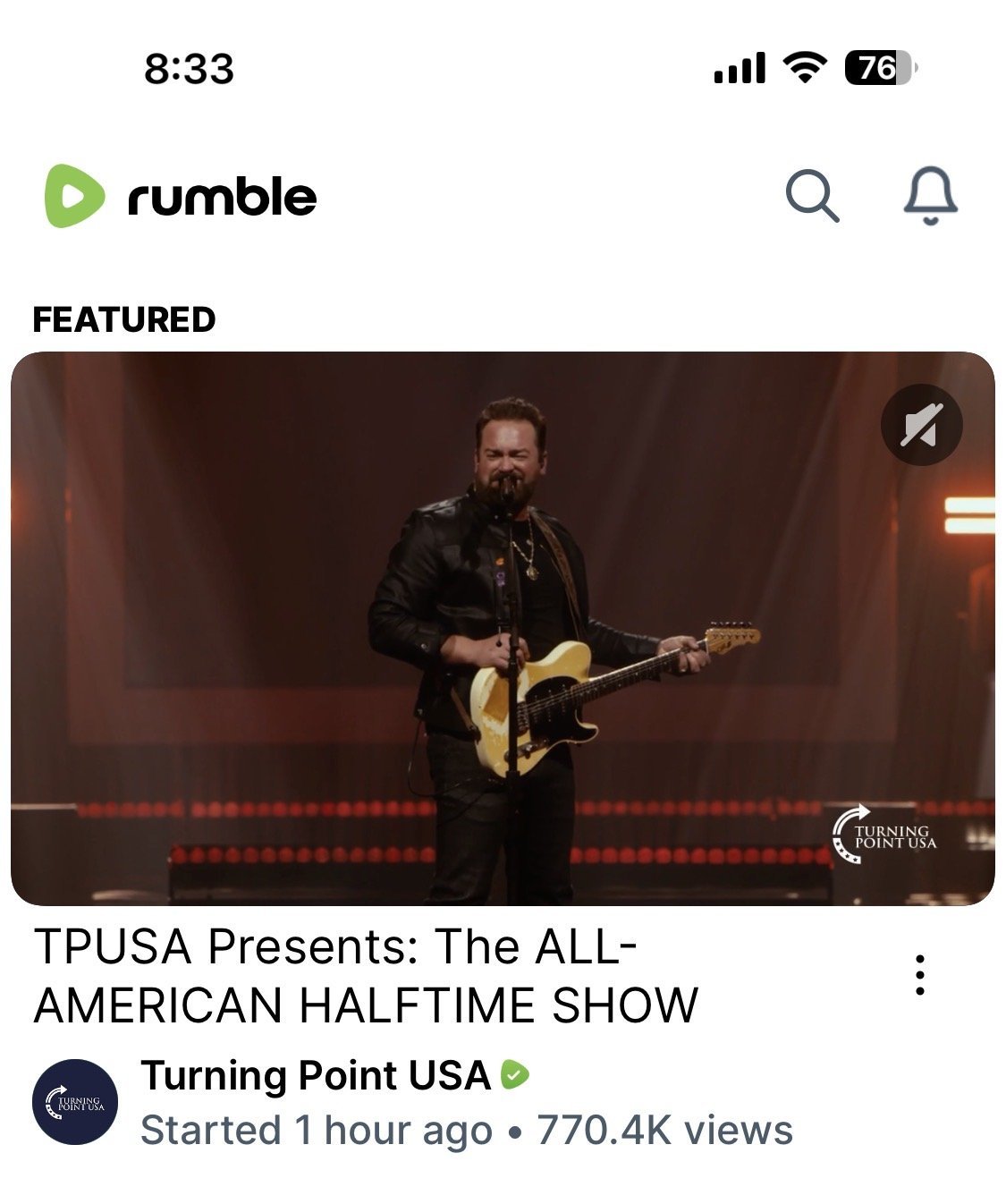 Musician performing at the TPUSA All-American Halftime Show, showcasing a vibrant stage with dynamic lighting and an enthusiastic atmosphere.