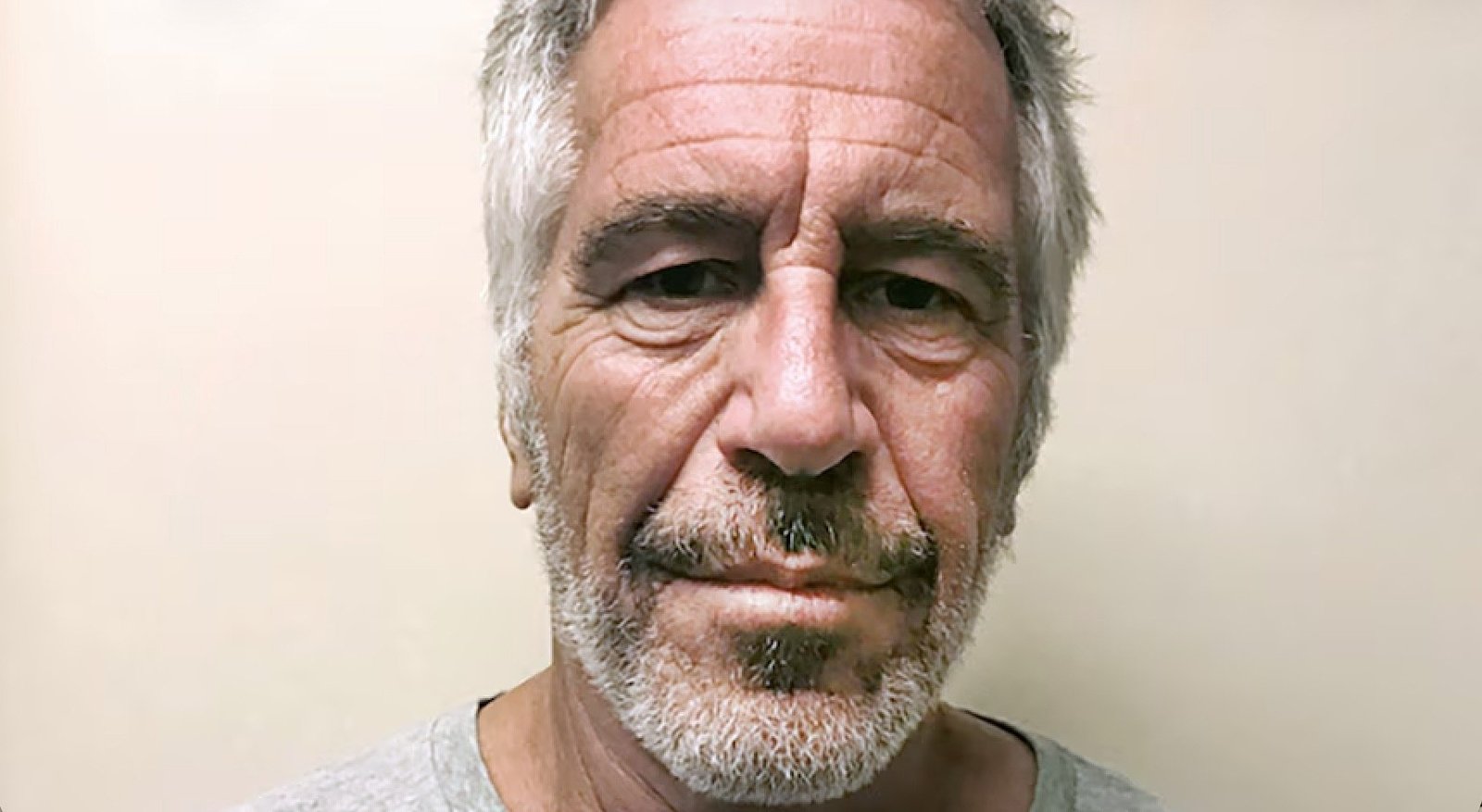Mugshot of a middle-aged man with gray hair and a beard, looking directly at the camera against a neutral background.
