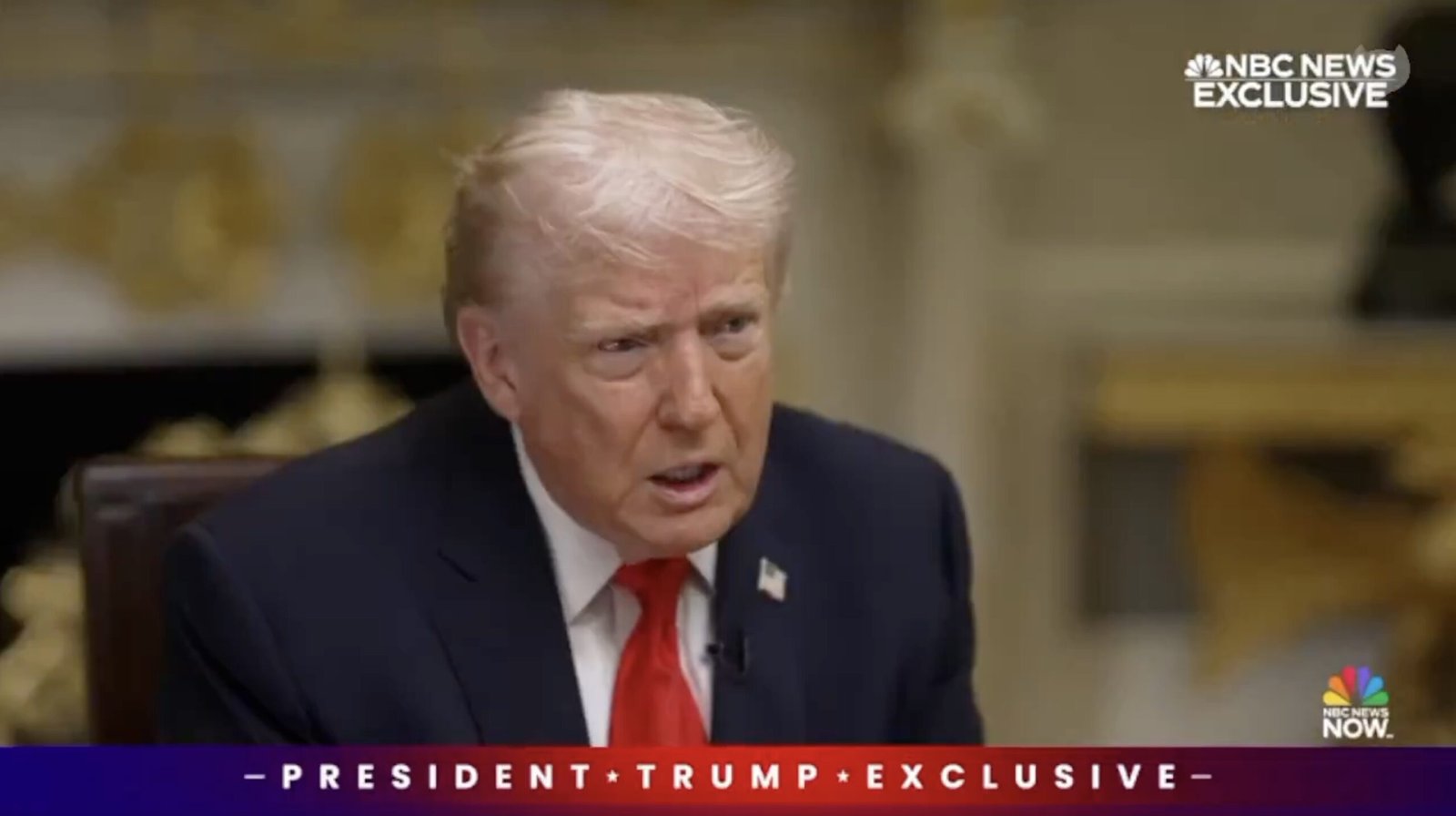 Donald Trump engaged in an exclusive interview, displaying a serious expression while seated in a formal setting.