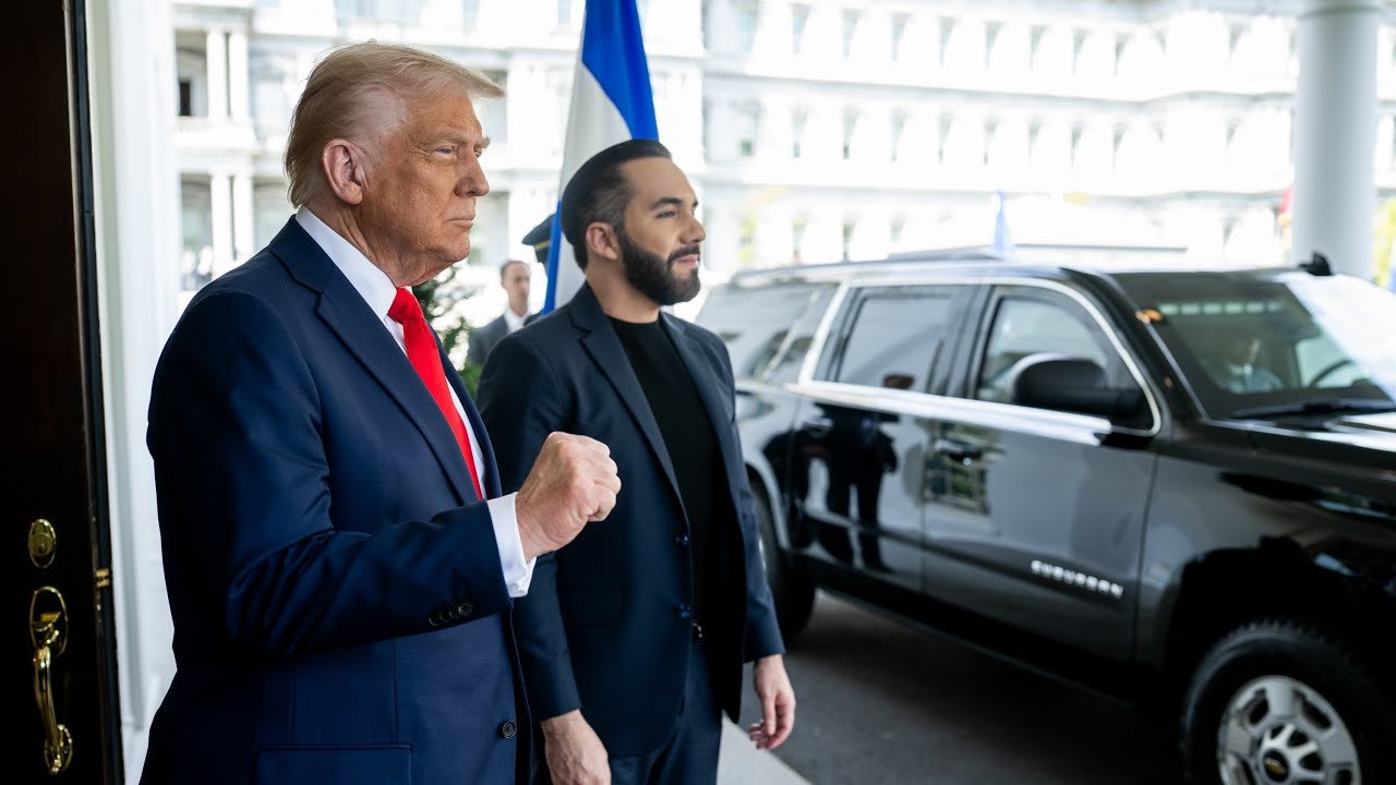 Former President Donald Trump stands outside the White House with a companion, both preparing to enter a black SUV, under a clear sky.